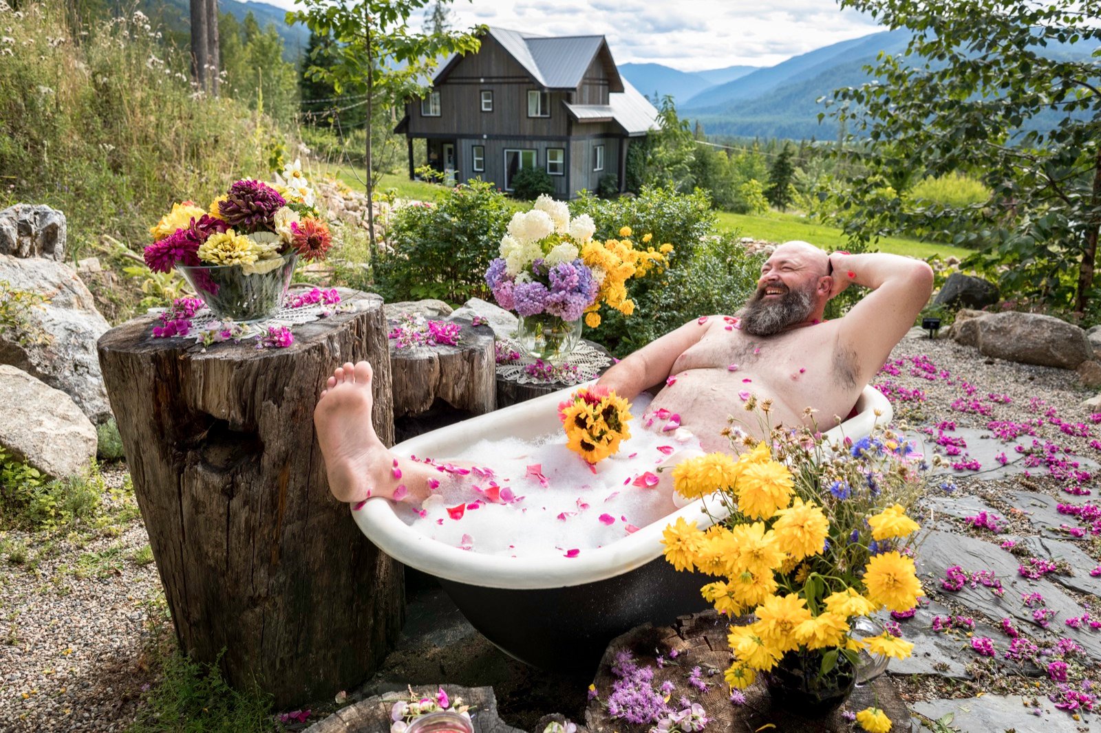 A flower-filled clawfoot bathtub overlooking mountains, Men in Tubs calendar