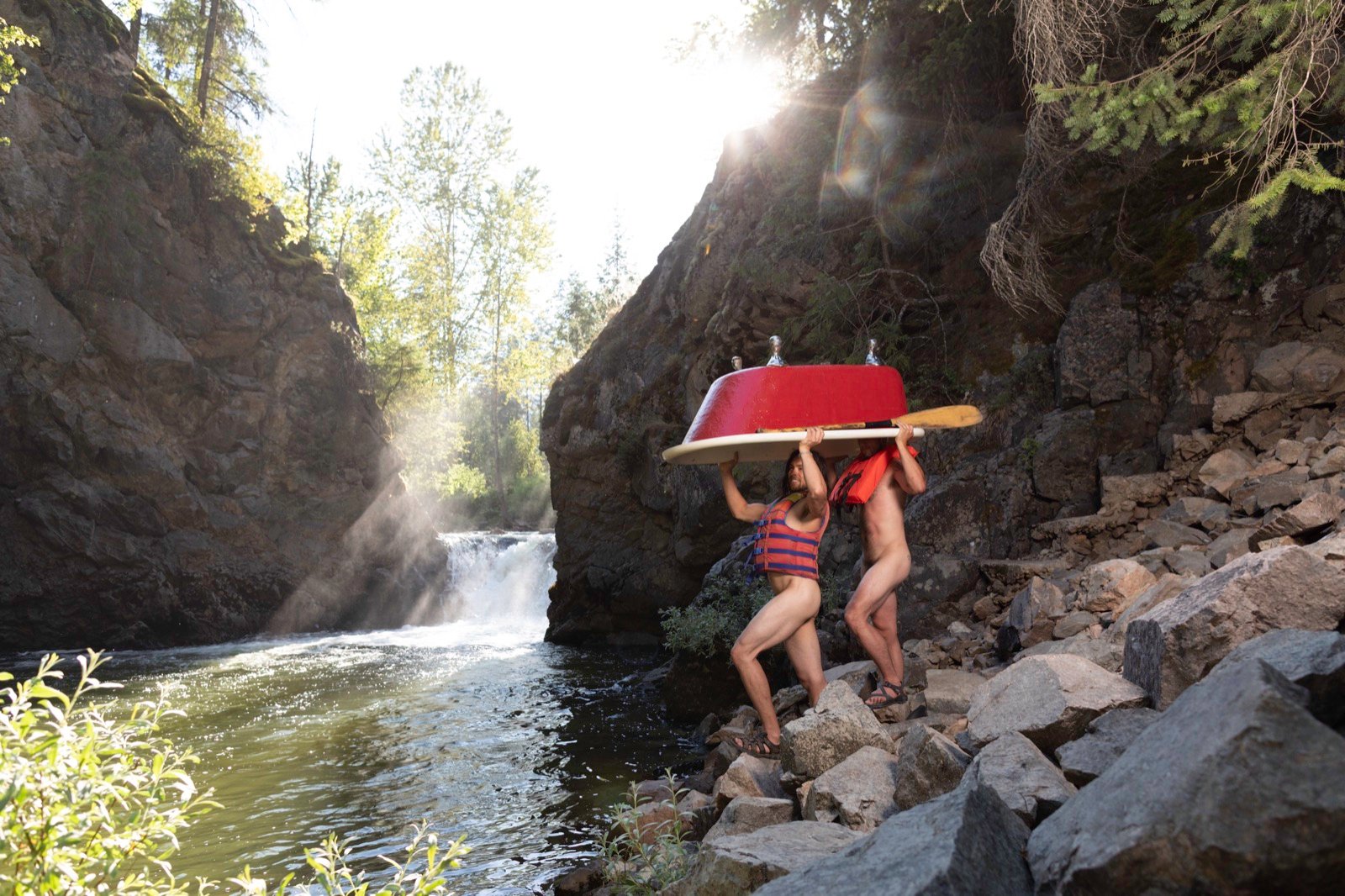 Two models portaging a canoe beside a waterfall, Men in Tubs calendar